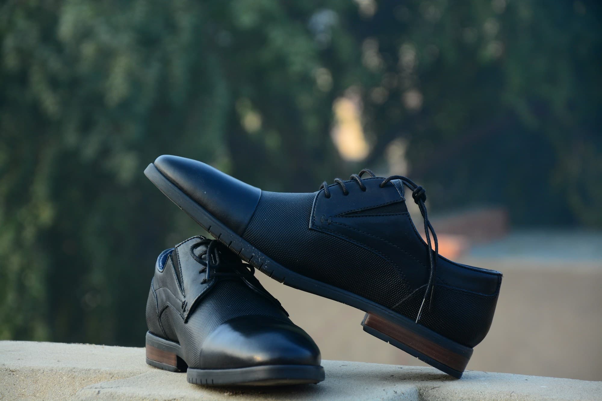 Real men's dress shoes photographed outdoors